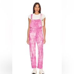 Free People's Done It Again With The Ziggy Denim Overall In Electric Bouquet. These Washed Tie-Dye Denim Overalls Feature 8-Pocket Styling And Rigid Denim Fabric With Button Sides. A Playful Twist On Classic Overalls, They Add A Pop Of Style To Your Wardrobe, Combining Comfort With A Vibrant, Eclectic Look. 100% Cotton Made In Morocco Machine Wash Pull-On Styling With Adjustable Shoulder Straps 8-Pocket Styling Rigid Denim Fabric With Button Sides Revolve Style No. Free-Wc331 Manufacturer Style Pastel Overalls, Tie Dye Overalls, Free People Overalls, Space Cowgirl, Tie Dye Denim, Jean Overalls, Pink Tie, Free People Jeans, Pink Tie Dye