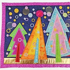 a colorful quilted wall hanging with different colored trees on it's side and bubbles in the air