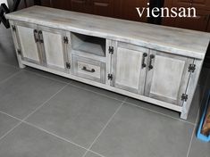 a large wooden cabinet sitting on top of a tile floor