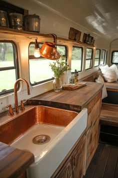 a kitchen area with sink, stove and window in the back ground next to an rv