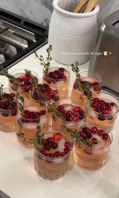 several glasses filled with drinks sitting on top of a counter