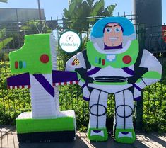 an inflatable buzz lightyear is sitting next to another toy that looks like it's made out of legos