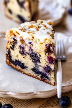 a slice of blueberry cheesecake on a plate with a fork