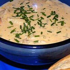 a blue bowl filled with soup and crackers