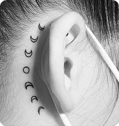 an ear with three phases on it and the word moon written in cursive writing