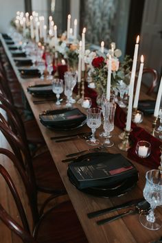 a long table is set with candles and place settings for an elegant dinner or party