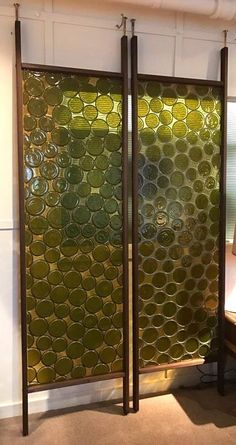 a room divider made out of metal and glass with a lamp on the side