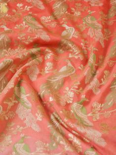 an orange and gold fabric with leaves on it