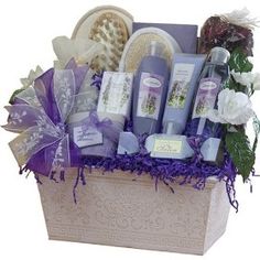 a gift basket filled with lots of different items and flowers on top of the words, girl - girl girlfriend gifts