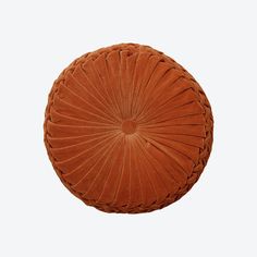 an orange round cushion on a white background