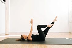 a woman is doing yoga on a mat