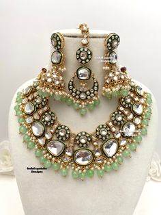 Premium quality Kundan Necklace comes with elegant Jhumki Earrings and Tikka/ trendy Indian bridal set/Premium Quality Polki and Kundan Jewelry/mint/pista/sage green  All items are shipped from Brampton, Ontario, Canada. If you need your item by a certain day, please reach out to us for express delivery option before placing the order so that we can update the shipping for you. Standard shipping/delivery timeline Below are the delivery timeline estimates. We dispatch all orders by the next busin Traditional Pista Green Jewelry For Wedding, Pista Green Jewelry For Festive Wedding, Green Chandbali Bridal Earrings For Wedding, Green Bridal Earrings For Wedding, Festive Green Bridal Earrings For Wedding, Green Kundan Jewelry For Wedding, Green Meenakari Bridal Earrings For Wedding, Round Green Meenakari Jewelry Set, Green Jewelry Sets With Stone Work