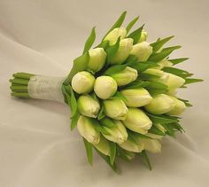 a bouquet of flowers sitting on top of a white sheet