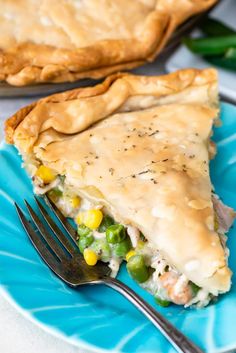 a piece of pie on a blue plate with a fork and green beans next to it