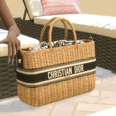 a wicker bag with the name christian dior on it sitting on a patio