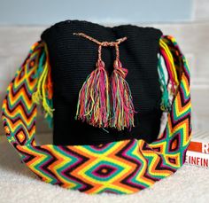 a black bag with colorful tassels on it