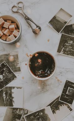 a table topped with pictures and a bowl of food