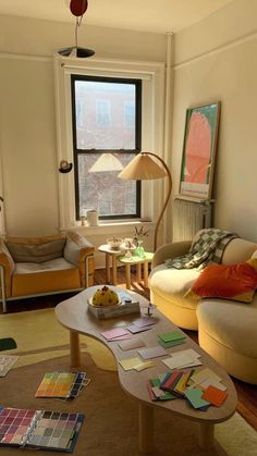 a living room filled with furniture and lots of windows