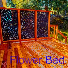 a wooden deck with laser cut screens on it and the words flower bed written in blue