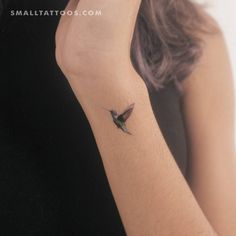 a small hummingbird tattoo on the wrist