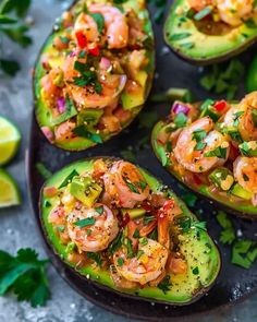 stuffed avocados with shrimp and cilantro garnished with lime wedges