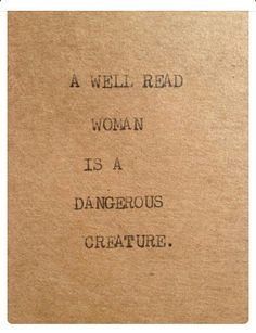 a well read woman is a dangerous creature written on a piece of brown paper with black ink