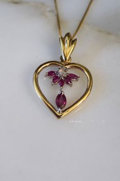 Metal: 14kt Yellow And White Gold Stone: Ruby And Diamond Shape: Marquise- Shape And Round Approximate Ruby Weight: .66 ctw Approximate Diamond Weight: .10 ctw Weight of entire piece with chain: 6.60 grams Type of Chain: .80mm Box Chain Type of Clasp: Spring Clasp Pendant Dimensions: 32.24mm long including bail, and 20.65mm wide. Length of 14kt yellow gold chain: Please select. If you don't see your desired length please state in note box at checkout. Thank you. 14k Gold Heart Pendant Diamond Necklace For Anniversary, Heirloom Oval Jewelry For Valentine's Day, Classic Diamond Cut Necklace For Valentine's Day, Classic Round Diamond Necklace For Valentine's Day, Exquisite Diamond Gemstone Necklace For Anniversary, Fine Jewelry Stamped 14k For Valentine's Day, Oval Yellow Gold Jewelry For Valentine's Day, Valentine's Day Yellow Gold Oval Jewelry, Valentine's Day Classic Round Diamond Necklace