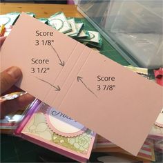 a person holding up a piece of pink paper with the measurements for each item on it