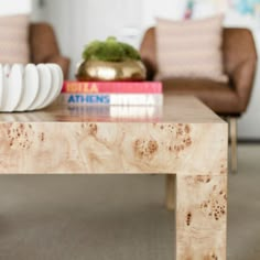 a coffee table with plates on it in a living room