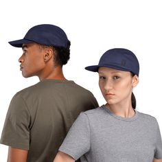 two people standing next to each other with hats on their heads and one wearing a gray t - shirt