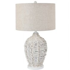 a white table lamp with a beige shade