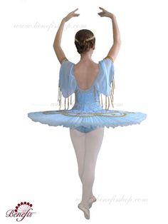 the ballerina is dressed in blue and has her arms raised up to the side