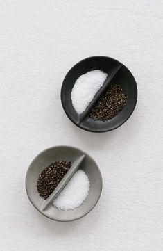 two bowls with salt and pepper on them