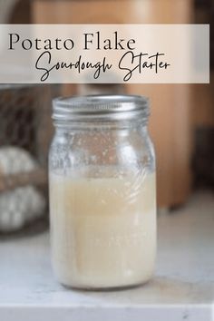 a glass jar filled with liquid sitting on top of a counter