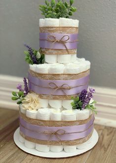 a three tiered cake with flowers and burlocks on the top is made out of marshmallows