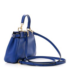 This is an authentic FENDI Shiny Nappa Micro Peekaboo Iconic Satchel in Bluette. This chic micro tote is crafted of Nappa soft leather in blue. The bag has a looping leather strap top handle with gold ring loops, a detachable strap, and a prominent gold turn lock. This releases to a grey suede panel interior with leather card slots. Fendi Crossbody Bag, Fendi Peekaboo Bag, Fendi Shoulder Bag, Fendi Peekaboo, Envelope Wallet, Phone Pouch, Grey Suede, Boston Bag, Strap Top