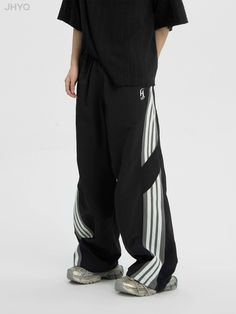 Track pants with a side line.

This season's trendy sports style loose and wide silhouette.

A must-have item that has a loose yet fashionable feel and is perfect for a clean look.
◾️Model
Height/Weight：168cm(66.1in)/47.5kg(104.7lb)
Fitting Size：S

Height/Weight：183cm(72.0in)/47.5kg(145.5lb)
Fitting Size：XL
◾️Material
nylon 100% Black Pants With Contrast Stripes For Streetwear, Sporty Baggy Wide Leg Pants, Sporty Black Wide Leg Pants With Pockets, Sporty Wide-leg Pants For Streetwear, Sporty Wide Leg Pants For Streetwear, Sporty Black Wide Leg Pants, Sporty Black Wide Leg Pants For Spring, Casual Wide Leg Sweatpants With Contrast Stripes, Black Wide-leg Pants With Contrast Stripes