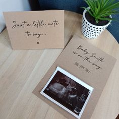 a couple of cards sitting on top of a table next to a potted plant