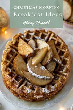 a waffle topped with apples and powdered sugar on top of a white plate