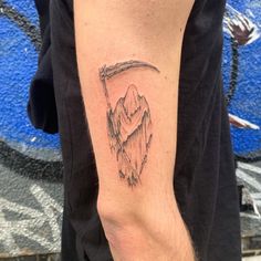 a man with a mountain tattoo on his arm