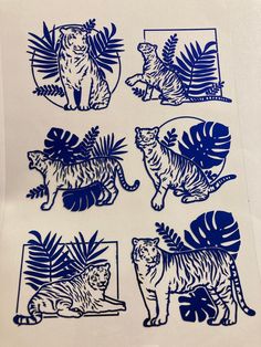 blue and white paper cut images of tigers