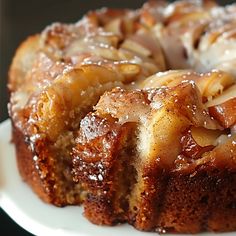 a bundt cake on a white plate covered in icing