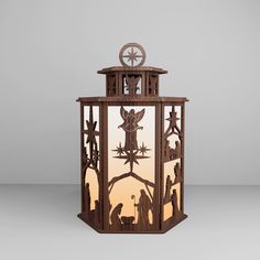 a wooden lantern with an image of the nativity scene in it's center