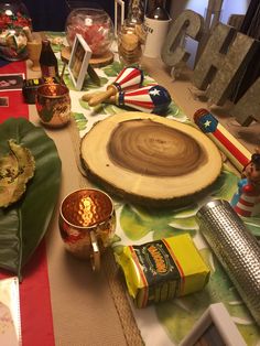 a table topped with lots of different types of food and decorating utensils