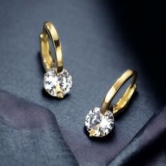 Discover the epitome of elegance with our stunning Diamond Drop Hoop Earrings, expertly crafted from 14k Gold Plated 925 Sterling Silver. Each earring features a brilliant round-cut Moissanite stone, sized at 6.5mm (1.0ct each), ensuring a dazzling sparkle that captures the eye. Available in both White Gold and Yellow Gold, these vintage-inspired classic earrings are the perfect accessory for any special occasion. Key Features: Stone Cut: Round Stone Size: 6.5mm (1.0ct each) Color Options: White Earring Gift, Classic Earrings, Moissanite Earrings, Earrings Hoop, Diamond Drops, Diamond Drop Earrings, Jewelry Earrings Hoops, Wedding Earrings, Gold Style