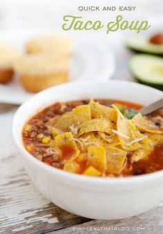 a white bowl filled with taco soup and topped with tortilla chips