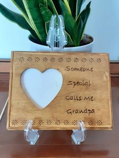 a wooden sign that says someone special calls me grandpa with a white heart on it