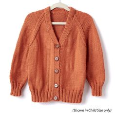 an orange cardigan sweater hanging on a hanger