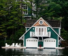 a house on the water surrounded by trees