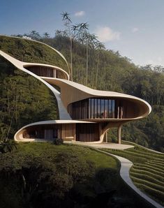 an unusual house in the middle of a lush green hillside with stairs leading up to it